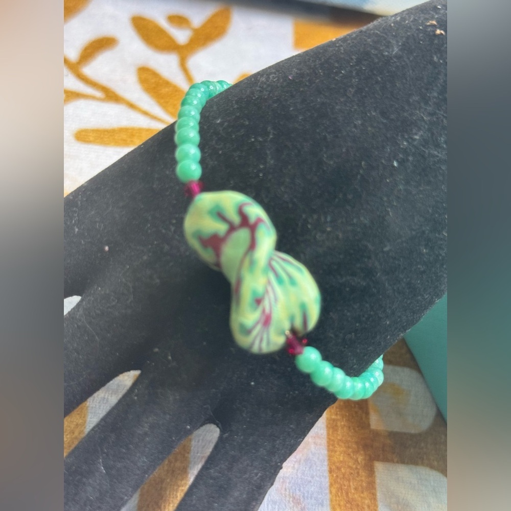 Green Beaded Bracelet with Twisted Charm